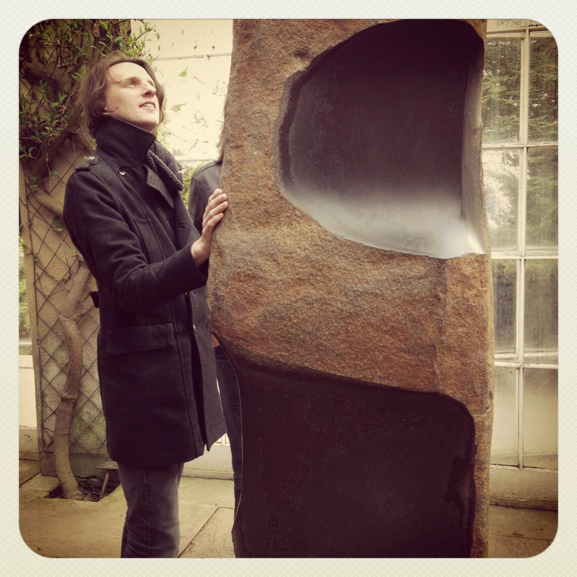 James and stroking a Barbara Hepworth sculpture